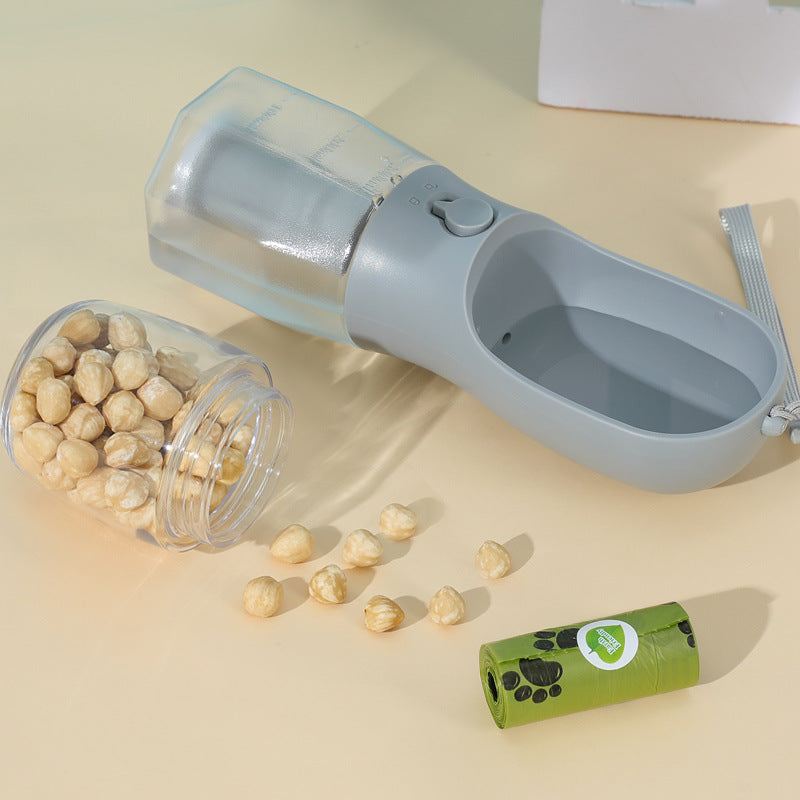Pet travel water bottle withfood dispenser and a container of pet food on a beige surface