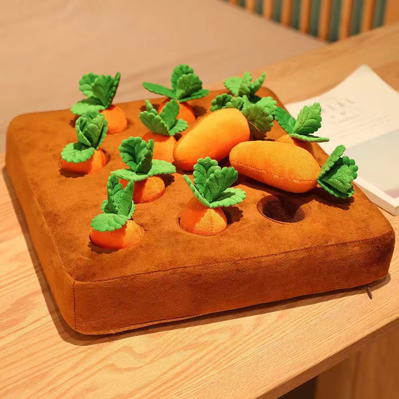 Carrot puzzle mat toy with plush carrots and green leaves on brown felt base for pet foraging games.