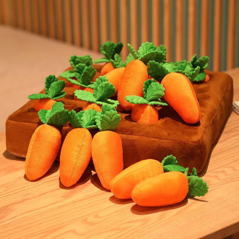 Carrot plush toy puzzle mat with orange fabric carrots and green leaves on brown felt base for pet foraging play.