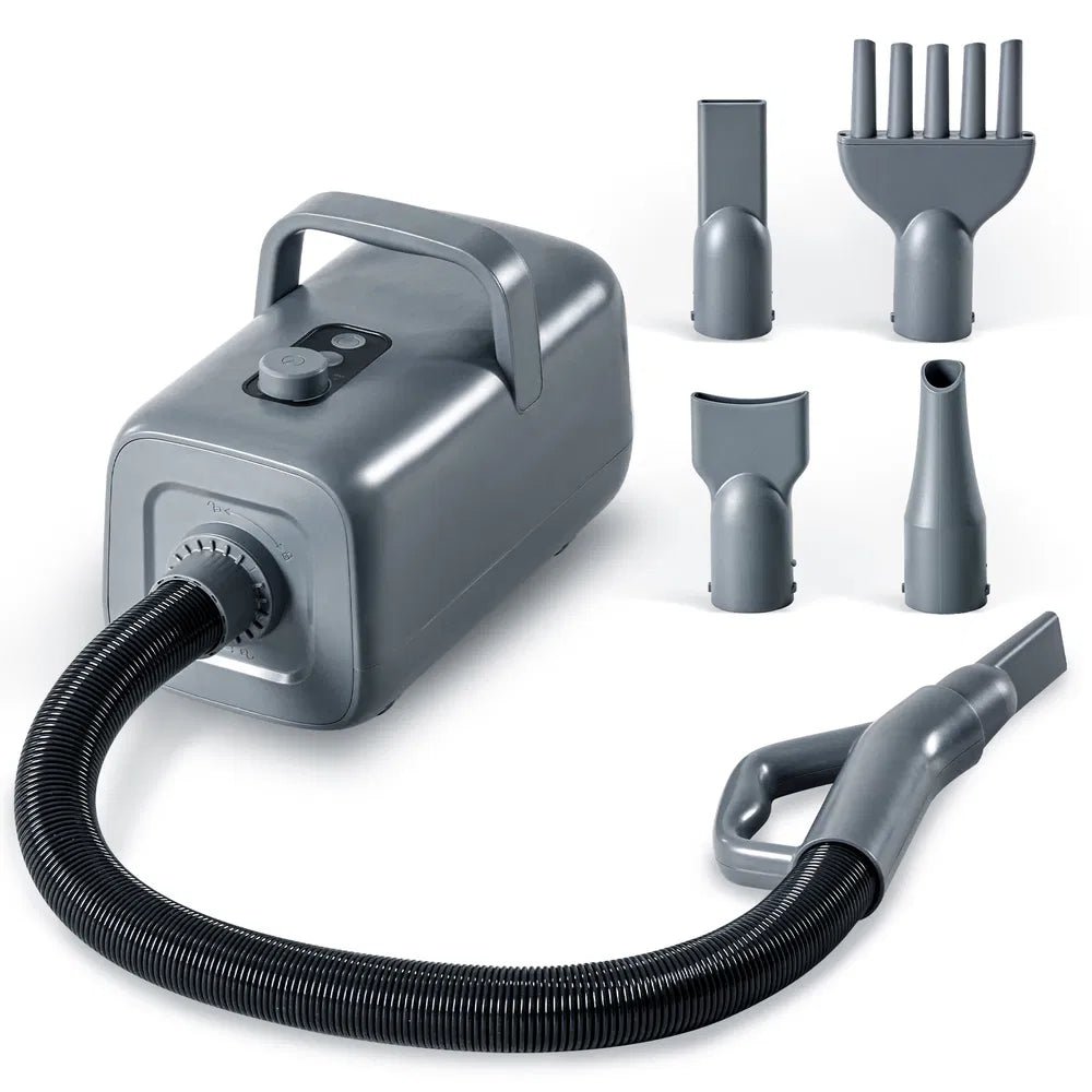 Gray handheld vacuum cleaner with various attachments on a white background
